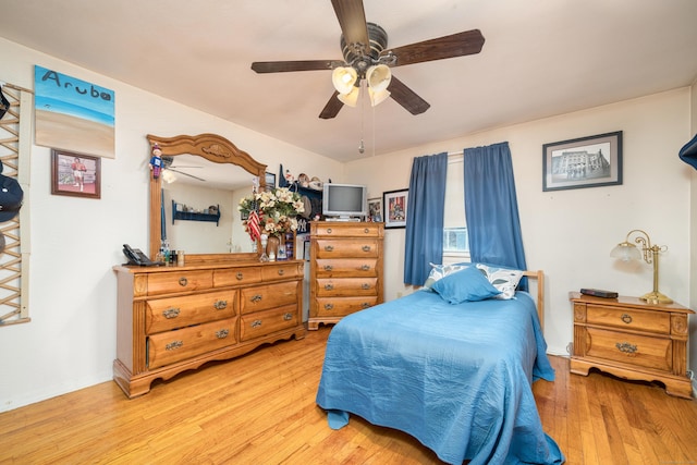 bedroom featuring a ceiling fan and wood finished floors