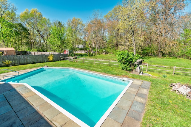 view of pool featuring a lawn, a fenced in pool, and a fenced backyard