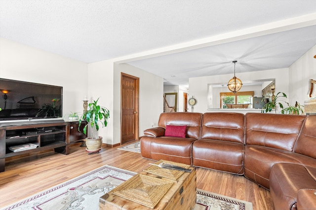 living room featuring an inviting chandelier and wood finished floors