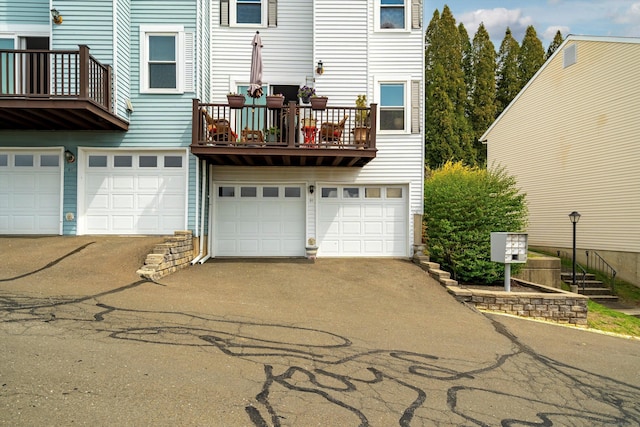 55 Mill Plain Rd Unit 8-1, Danbury, CT 06811 - back of property featuring an attached garage, a balcony, and driveway