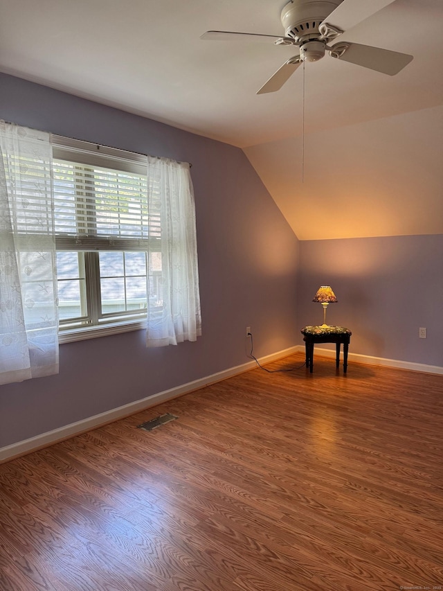 bonus room with ceiling fan, visible vents, wood finished floors, baseboards, and lofted ceiling