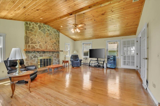 living area featuring a fireplace, a ceiling fan, wood finished floors, vaulted ceiling, and wood ceiling