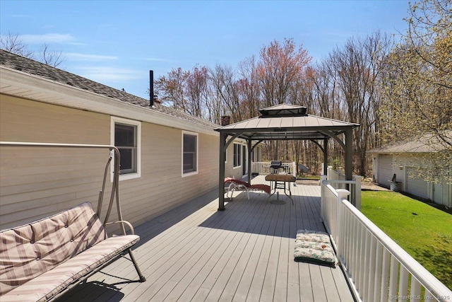 wooden terrace featuring a gazebo and a yard