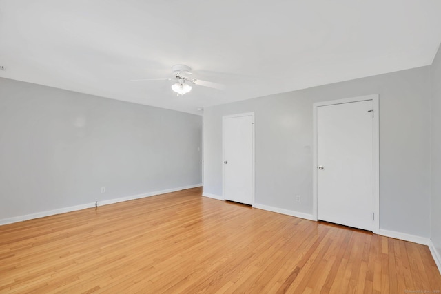 unfurnished room with baseboards, ceiling fan, and wood finished floors