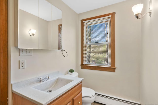 bathroom with vanity, a baseboard radiator, and toilet