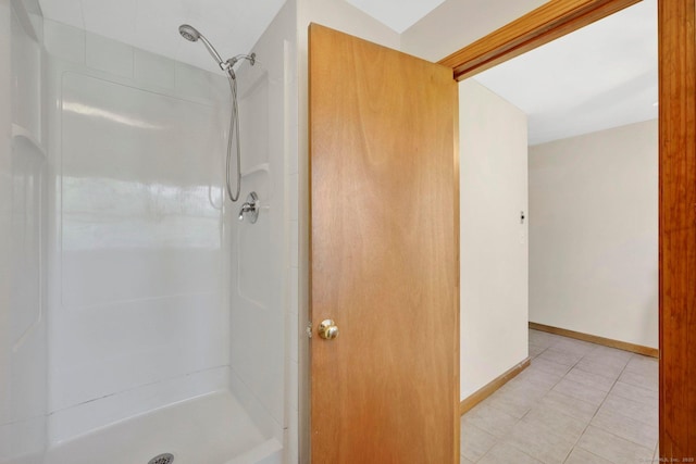 full bathroom with tile patterned floors, a shower stall, and baseboards
