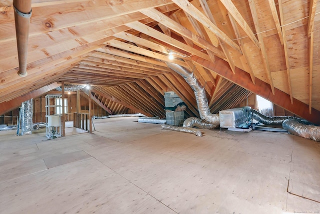 unfinished attic featuring an upstairs landing