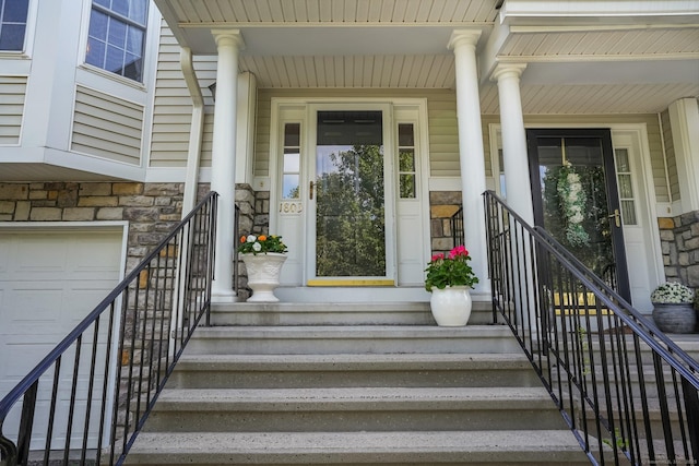 1803 Revere Rd, Danbury, CT 06811 - doorway to property with covered porch, an attached garage, and stone siding