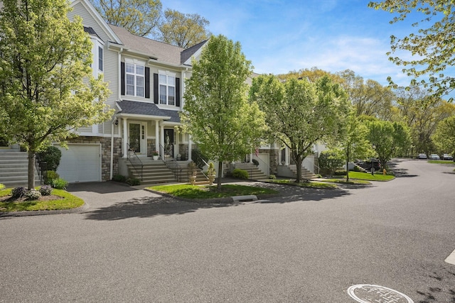 1803 Revere Rd, Danbury, CT 06811 - view of front of property with an attached garage, driveway, and stone siding