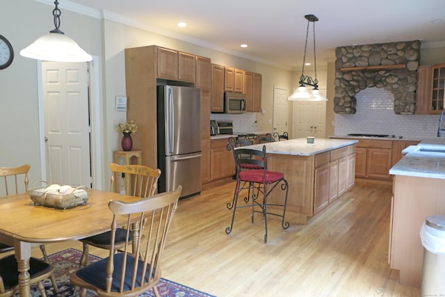46 Brookfield Rd, Seymour, CT 06483 - kitchen featuring stainless steel appliances, tasteful backsplash, light wood-type flooring, crown molding, and a kitchen island