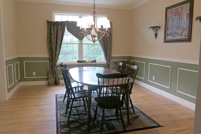 46 Brookfield Rd, Seymour, CT 06483 - dining room featuring a chandelier, crown molding, light wood-type flooring, wainscoting, and a decorative wall