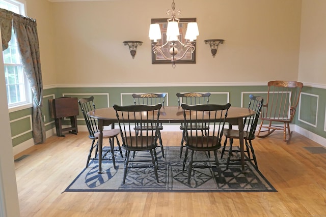 46 Brookfield Rd, Seymour, CT 06483 - dining space with wood finished floors, a wainscoted wall, a chandelier, and baseboards