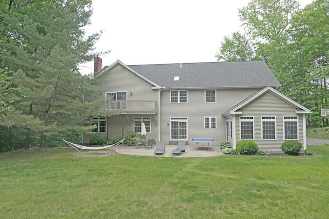 46 Brookfield Rd, Seymour, CT 06483 - back of property featuring a chimney, a patio, a lawn, and a balcony