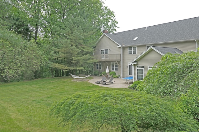 46 Brookfield Rd, Seymour, CT 06483 - back of property featuring a patio area, a chimney, a lawn, and a balcony