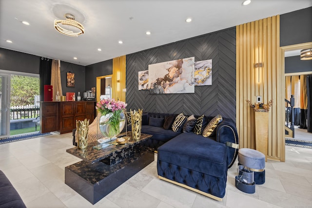 living room featuring recessed lighting, wallpapered walls, and an accent wall
