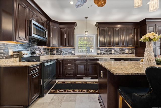 kitchen with dark brown cabinets, light stone countertops, appliances with stainless steel finishes, a ceiling fan, and decorative backsplash