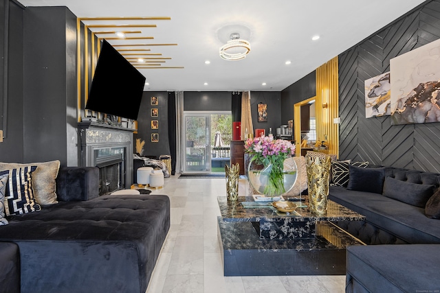living room with an accent wall, a fireplace, and recessed lighting