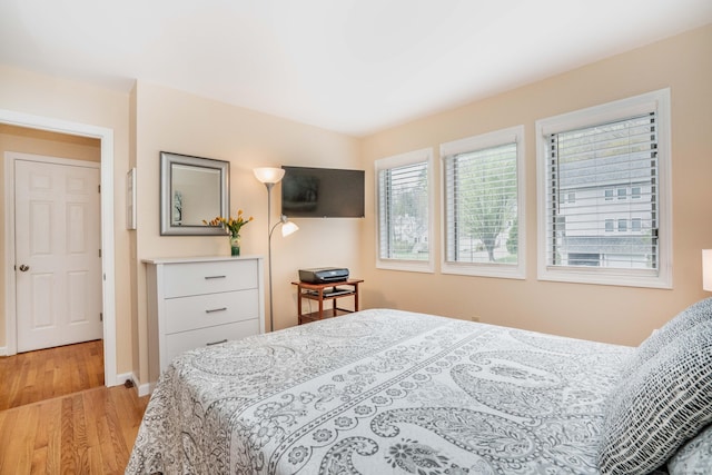 bedroom with baseboards and wood finished floors