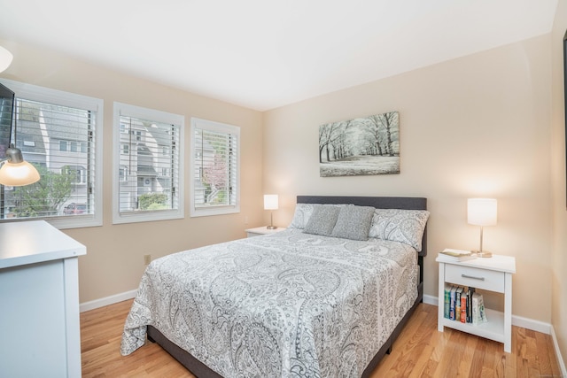 bedroom featuring baseboards and light wood-style floors