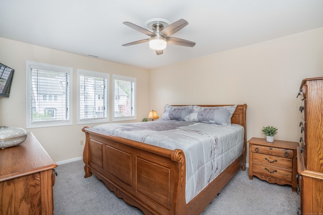 bedroom with a ceiling fan, baseboards, light colored carpet, and visible vents