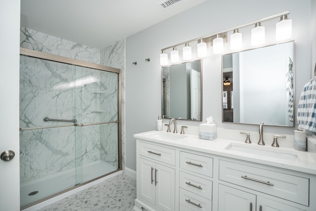 full bathroom with a sink, a marble finish shower, double vanity, and visible vents