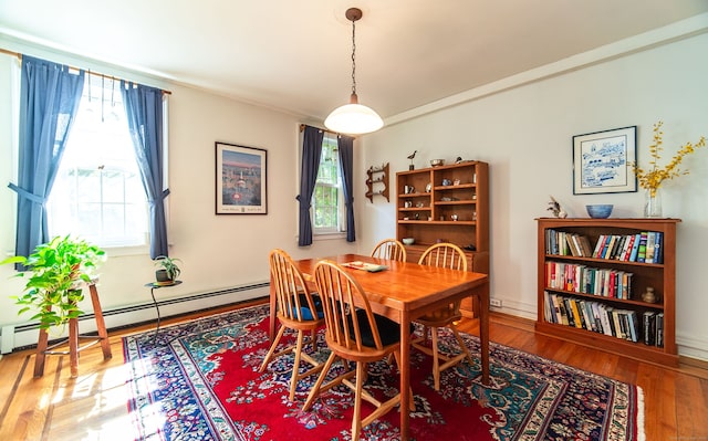 496 Whitney Ave Unit 1C, New Haven, CT 06511 - dining area with a baseboard radiator, a healthy amount of sunlight, and wood finished floors