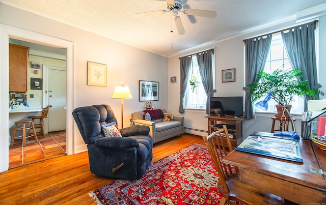 496 Whitney Ave Unit 1C, New Haven, CT 06511 - living area featuring a ceiling fan, plenty of natural light, wood finished floors, and baseboard heating