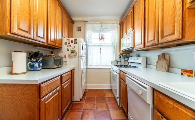 496 Whitney Ave Unit 1C, New Haven, CT 06511 - kitchen with light countertops, a toaster, brown cabinetry, and white appliances