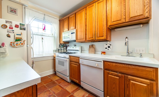 496 Whitney Ave Unit 1C, New Haven, CT 06511 - kitchen with brown cabinets, white appliances, light countertops, and a sink