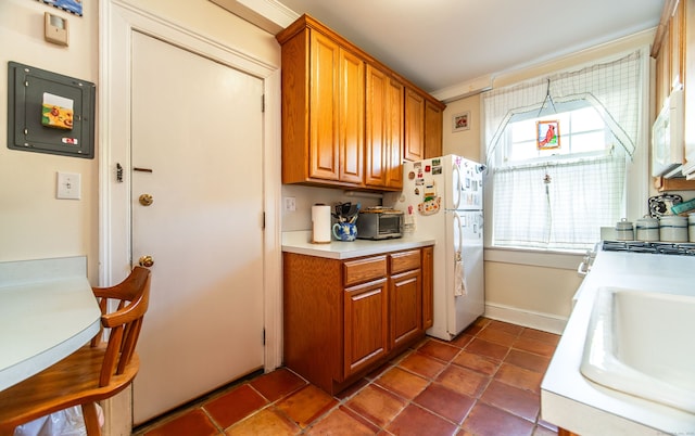 496 Whitney Ave Unit 1C, New Haven, CT 06511 - kitchen with light countertops, brown cabinets, a sink, and white appliances