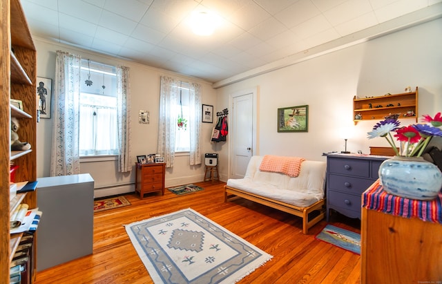 496 Whitney Ave Unit 1C, New Haven, CT 06511 - living area featuring crown molding, light wood-style flooring, and a baseboard radiator