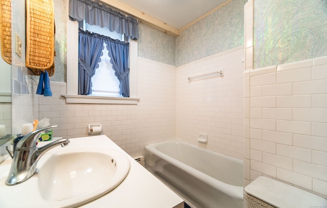 496 Whitney Ave Unit 1C, New Haven, CT 06511 - bathroom with a sink, tile walls, a wainscoted wall, and a bathtub