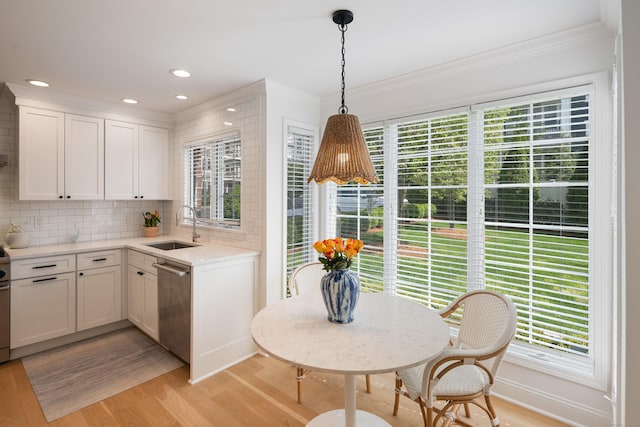 1 Maple St Unit 1, New Canaan, CT 06840 - kitchen featuring a sink, ornamental molding, light wood-style floors, and dishwasher