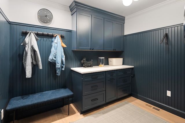 1 Maple St Unit 1, New Canaan, CT 06840 - mudroom with light wood finished floors, crown molding, visible vents, and wainscoting