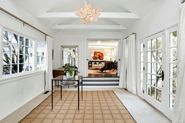 sunroom with beamed ceiling, a notable chandelier, french doors, and visible vents