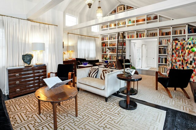 sitting room with high vaulted ceiling and a wealth of natural light