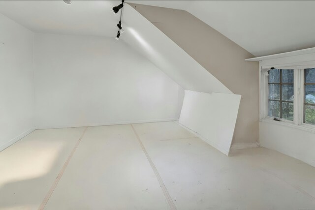 bonus room featuring concrete floors and lofted ceiling
