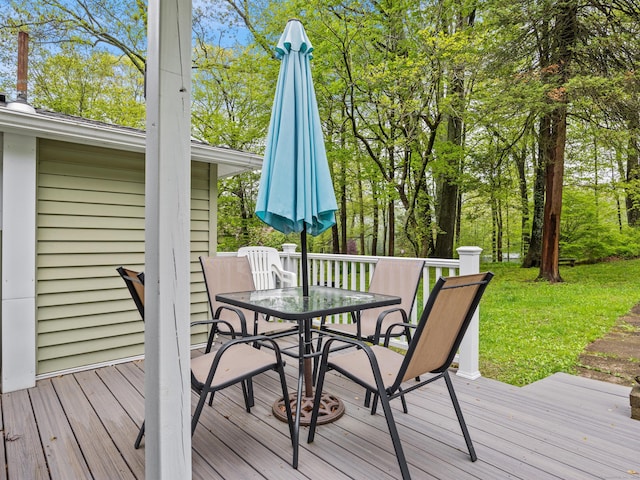 wooden deck featuring outdoor dining area