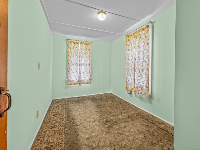 spare room with baseboards