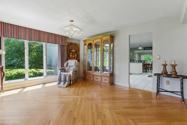 17 Pasture Ln, Glastonbury, CT 06073 - sitting room featuring a chandelier, a textured ceiling, and baseboards