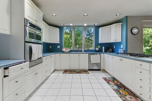 17 Pasture Ln, Glastonbury, CT 06073 - kitchen with appliances with stainless steel finishes, a sink, white cabinets, recessed lighting, and light tile patterned floors