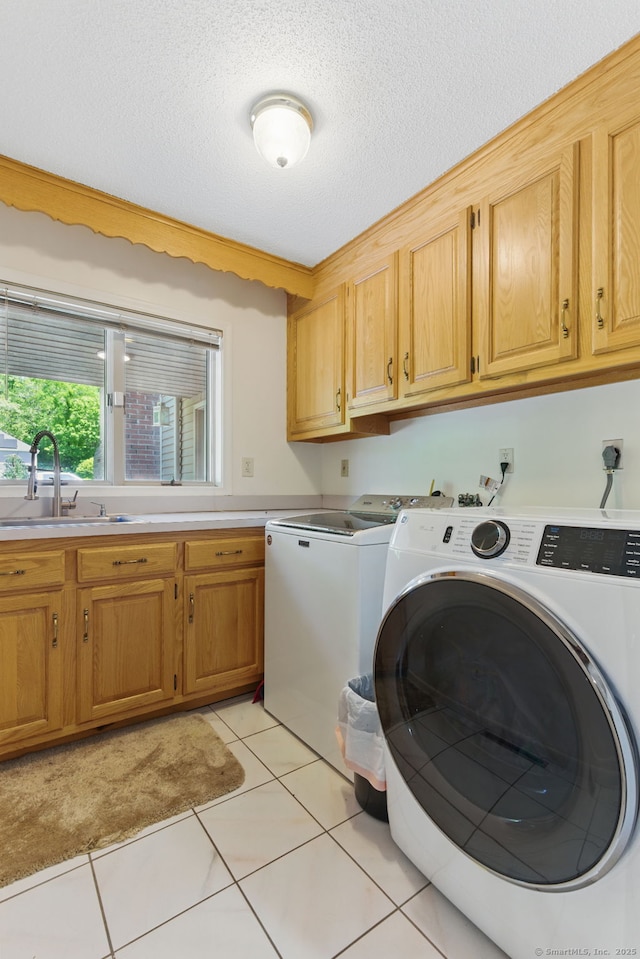 17 Pasture Ln, Glastonbury, CT 06073 - washroom featuring cabinet space, separate washer and dryer, light tile patterned floors, and a textured ceiling