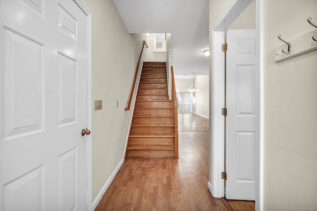 staircase with baseboards and wood finished floors