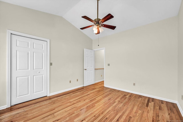 unfurnished bedroom with lofted ceiling, light wood-style floors, baseboards, and ceiling fan
