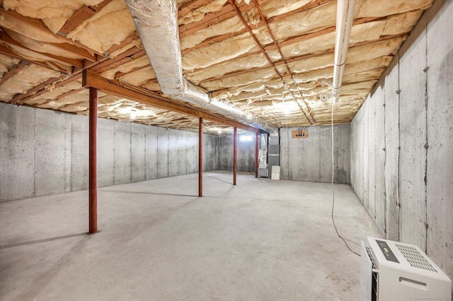unfinished basement featuring heating unit