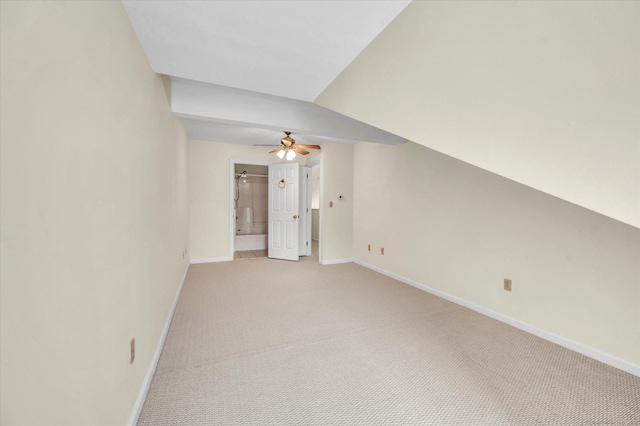 empty room featuring baseboards, ceiling fan, and light colored carpet