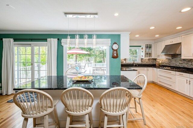 35 Hampton Ln, Stamford, CT 06903 - dining area featuring crown molding, healthy amount of natural light, light wood finished floors, and recessed lighting
