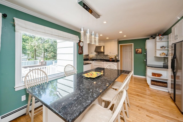 35 Hampton Ln, Stamford, CT 06903 - kitchen with baseboard heating, under cabinet range hood, freestanding refrigerator, ornamental molding, and open shelves