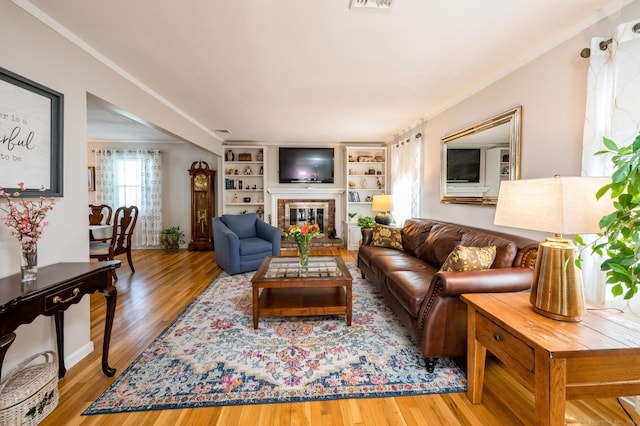 35 Hampton Ln, Stamford, CT 06903 - living room featuring wood finished floors, a fireplace, and crown molding