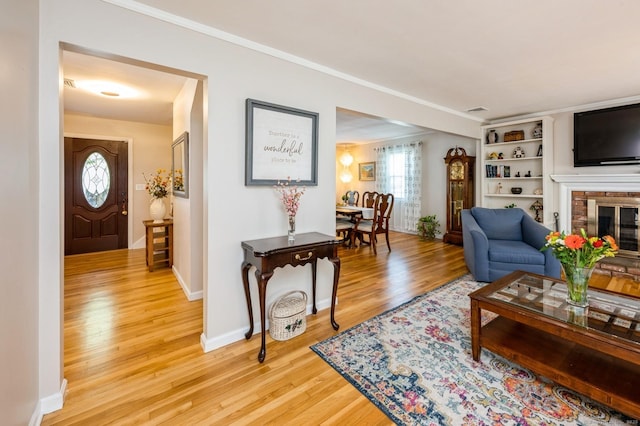 35 Hampton Ln, Stamford, CT 06903 - living area with light wood-type flooring, crown molding, a fireplace, and baseboards